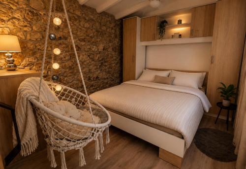 a bedroom with a swinging bed and a chair at Holiday House Pulina in Punat