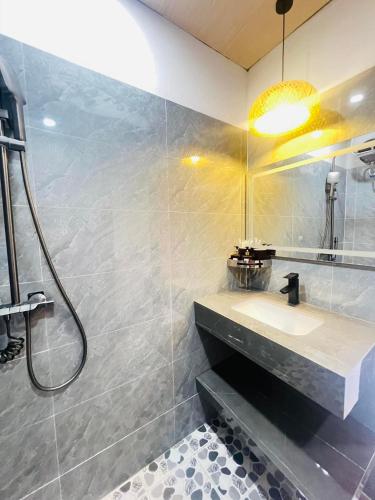 a bathroom with a sink and a shower at Du Già Khánh Chung homestay in Yên Minh