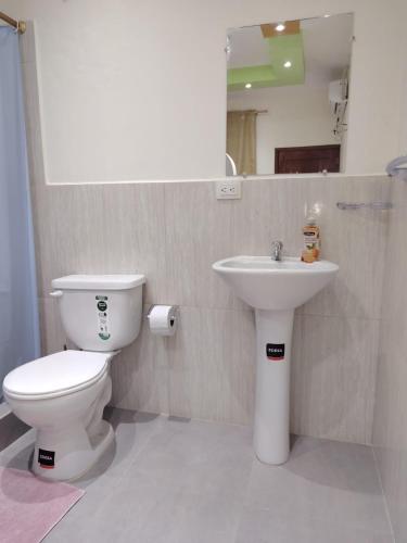 a bathroom with a toilet and a sink at CASA Sebastián in Puerto Baquerizo Moreno