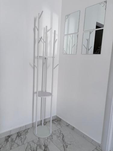 a white room with a mirror and a chair at Bella Home Residence in Roşu
