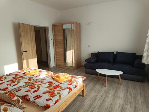 a living room with a bed and a couch at Ubytování Krucemburk in Křížová