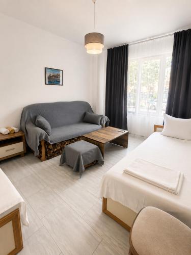 a living room with two beds and a couch at AnaBella Apartments Gabrovo in Gabrovo
