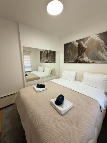 a room with two beds with hats on them at Apartman Mario in Čačak