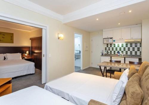 a hotel room with two beds and a living room at Alojamiento Center in Barraquero