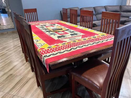 a table with a quilt on top of it at Zahara Lodge in Victoria Falls