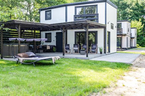 a white house with a patio and grass at Ale Jazz w cenie jacuzzi i basen in Nowe Miasto