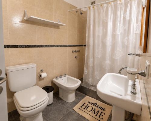 a bathroom with a toilet and a sink at Casa de los Cerros II in Vaqueros
