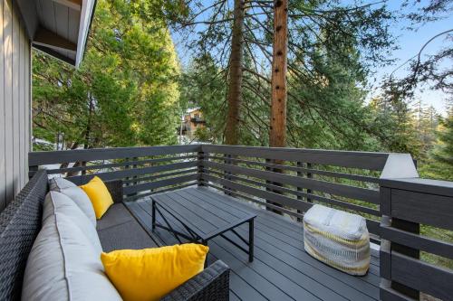 a patio with a couch and a table on a deck at Moonstar Lodge in Lake Arrowhead