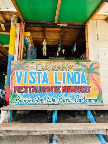 a sign for a vista liminia restaurant in a building at Vista Linda Cabaña in Playa Blanca