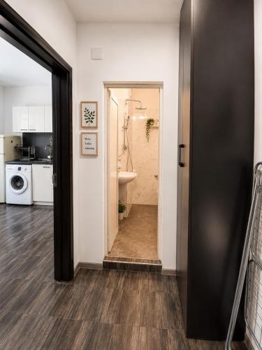 a hallway with a bathroom with a sink and a toilet at AnaBella Apartments Gabrovo in Gabrovo