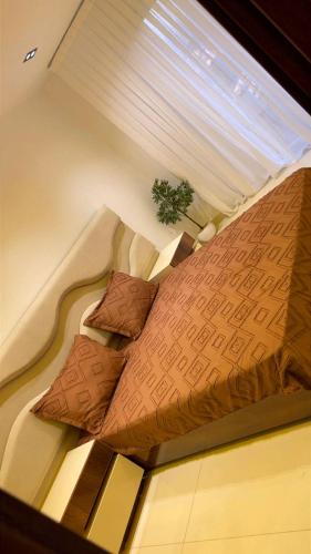 a large bed in a room with a window at Ayden Residence Béjaïa in Bejaïa