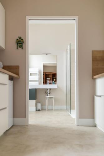 an open door into a kitchen with a table at Gîte de LA CHESNAYE in Cerelles