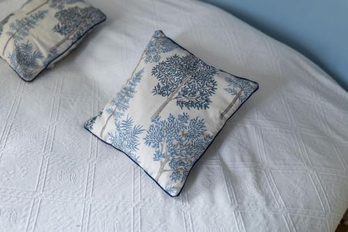 two blue and white pillows on a bed at Gîte de LA CHESNAYE in Cerelles
