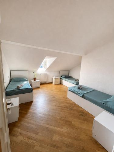 a room with two beds and a wooden floor at Green Hostel in Yerevan