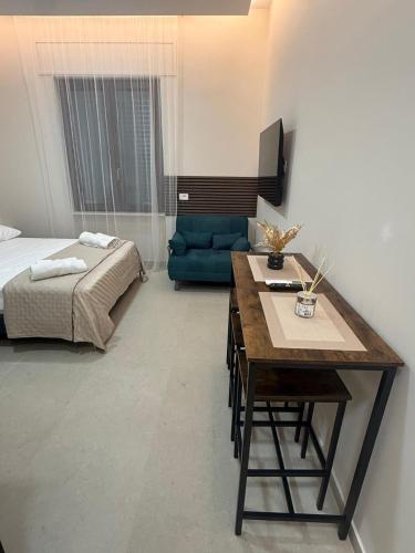 a bedroom with a bed and a desk and a couch at La Vista Suite and Rooms in Ladispoli