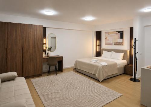 a hotel room with a bed and a desk at Piatra Studio Garden in Piatra Neamţ