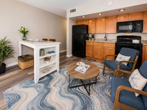 a kitchen and living room with a table and chairs at Royal Kahana 318 Studio Condo in Kahana