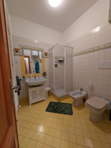a bathroom with a sink and a toilet and a shower at Casa Cachepot - Sweet Silvana in Ischia