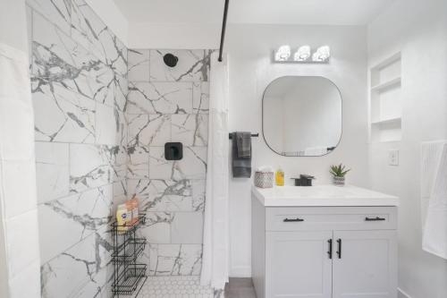a white bathroom with a marble wall at Ogden Base Camp in Ogden