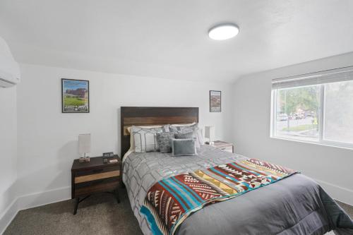 a bedroom with a large bed and a window at Ogden Base Camp in Ogden