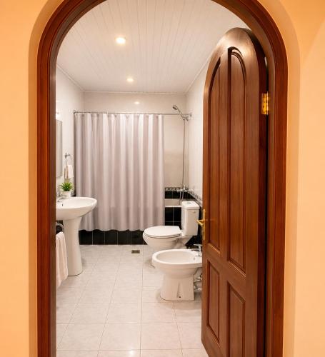 a bathroom with two toilets and a sink at Sunshine Boutique Hostel in Yerevan
