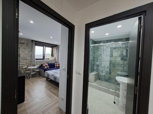 a bathroom with a glass door leading to a bedroom at La Casona de Regolfo in Regolfo