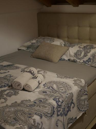 a bed with two rolled towels on it at Kuća za odmor Mate 