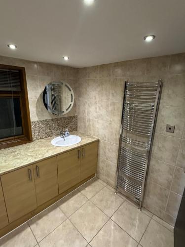 a bathroom with a sink and a shower at Plus Properties Leeds 2 in Bradford