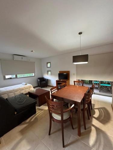 a living room with a table and a couch at Complejo Totoras in Pinamar