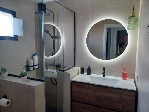 a bathroom with a sink and a shower with a mirror at Rosa de los Vientos 71 Renovado julio 2026 in Mijas Costa