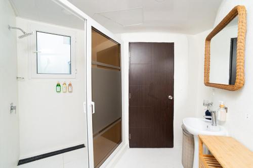 a bathroom with a shower and a sink at Casa Sofia 19 Guests, Steps From The Sea in Tela