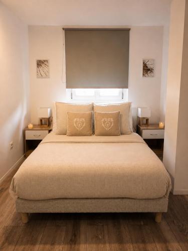 a bedroom with a large bed with two night stands at Sweet Home & Spa in Erstein