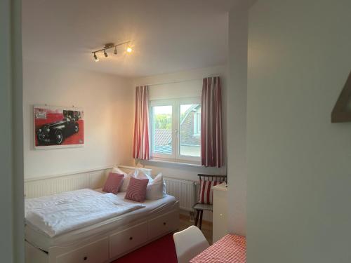 a bedroom with a bed and a window with a camera at Petite Bellevue II in Baden-Baden