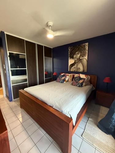 a bedroom with a large bed in a room at Flamingo Bay in Les Trois-Îlets