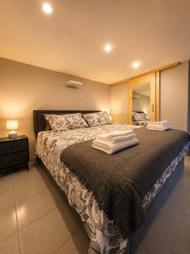 a bedroom with a bed with towels on it at ZONA NAVIGLI Design Loft , Proiettore schermo 80" in Milan