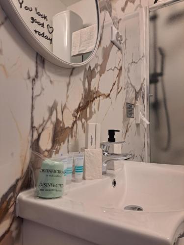 a bathroom with a sink and a mirror at Peron 4-City & Station Stay in Rijeka