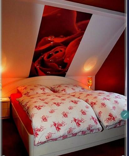 a bedroom with a bed with a red wall at Ferienwohnung Heideschwedin in Eschede