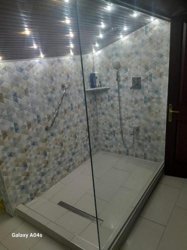 a shower with a glass door in a bathroom at Miji Stay in Fethiye