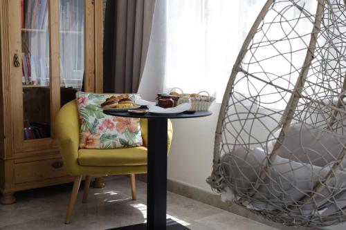 a table with a plate of food on it next to a chair at Amaryllis in Rogoznica