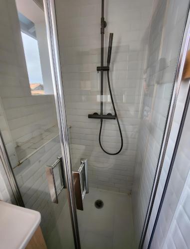 a bathroom with a shower with a glass door at Villa 16 personnes à 50m plage Sud in Lacanau