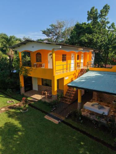 an overhead view of a yellow house with a yard at Los Tecales Hostal in Santa Catalina