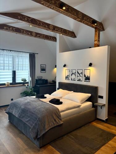 a bedroom with a large bed in a room at Apartamenty u Gąsiorów in Biały Dunajec