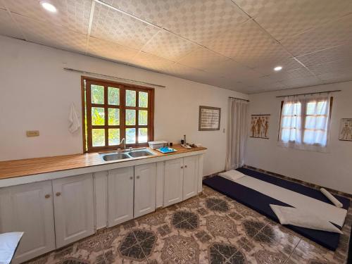 a kitchen with a sink and a counter top at Los Tecales Hostal in Santa Catalina