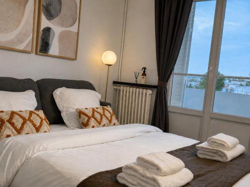 a bedroom with two beds with towels on them at Bright Studio Near Paris & Disneyland in Neuilly-Plaisance