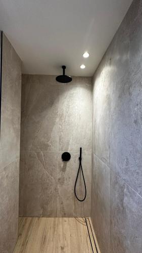 a bathroom with a shower in the corner of a room at Samothraki Belize Luxury Apartments in Samothraki