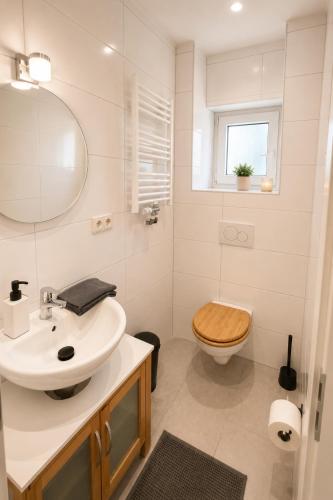 a white bathroom with a sink and a toilet at Hinterhaus am Schloss Karlsruhe in Karlsruhe
