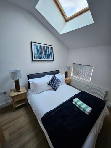 a bedroom with a large bed with a skylight at Union House in Stratford-upon-Avon