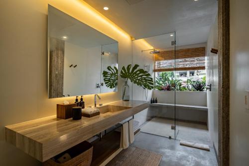 a bathroom with a sink and a mirror at The Tryst Puerto Vallarta LGBT Hotel in Puerto Vallarta