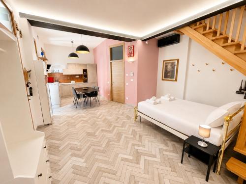 a bedroom with a bed and a dining room at Palazzo Degli Affreschi - Luxury Villa Verona in Verona