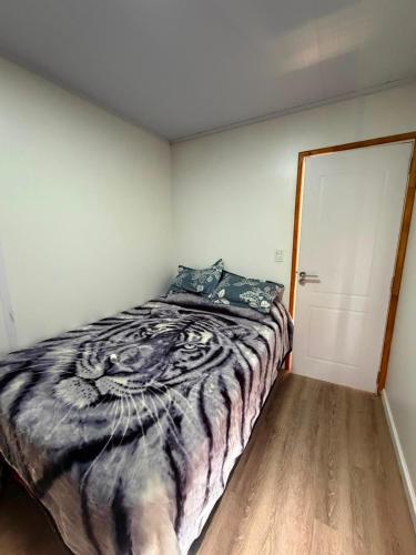 a bedroom with a bed with a tiger blanket at My Ideal in Balneario Argentino